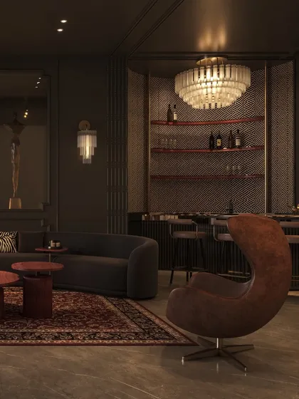 The lounge is designed for disconnecting and unwinding. A sculptural leather armchair provides a statement seating option, looking towards the bar and the main seating area.