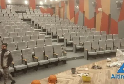 Workers are putting the finishing touches on the seating area and stage flooring. Our project management ensures that our AV installation timeline is perfectly coordinated with other construction and finishing work.