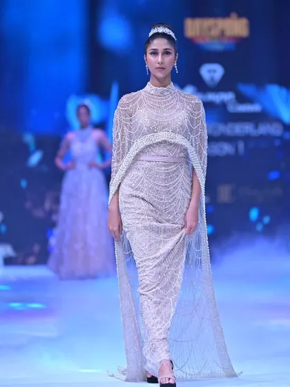 This design is where heritage meets high fashion. A fully hand-beaded gown with a dramatic, floor-length sheer cape, this piece from my GULFAM collection is for the woman who wants to make a statement of pure opulence.
