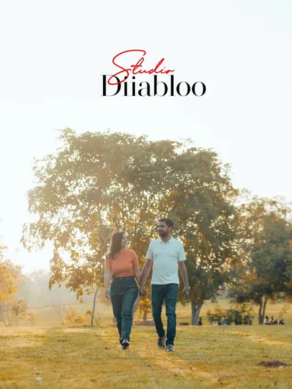 A simple, beautiful shot of a couple walking hand-in-hand through a park at golden hour. This image captures the peaceful and happy beginning of their journey together.