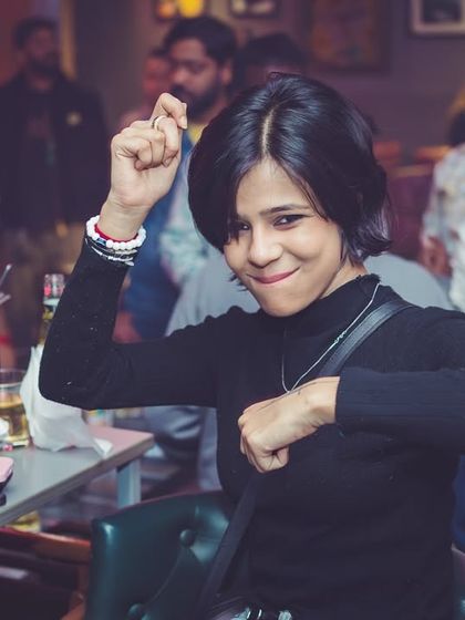 A partygoer showing off her dance moves at her table. The energy is everywhere at 'Mondaze'.