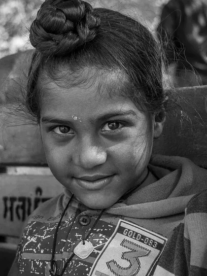 A close-up from the group sitting on the bench. This framing brings you closer to the children, allowing you to see the subtle smiles and curious looks on their faces.