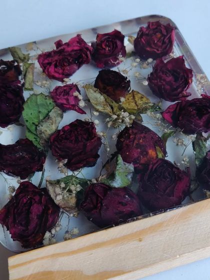 This resin block preserves a client's bouquet of roses, turning them into a permanent piece of art. The wooden base with an LED light makes the flowers glow beautifully.
