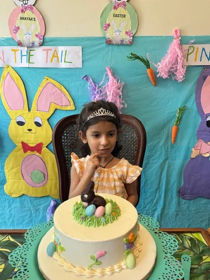 An Easter-themed playdate complete with a beautiful cake and festive decorations. This little girl is ready to celebrate with her friends.