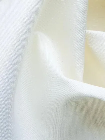 The pure, clean texture of a high-quality white cotton fabric, the foundation for the perfect white shirt.