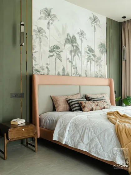 I believe a bedroom should be a personal sanctuary. Here, a stunning tropical wallpaper serves as an art piece, creating a serene backdrop for the custom-upholstered bed. The combination of soft textures, layered lighting, and bespoke furniture transforms this room into a tranquil escape.