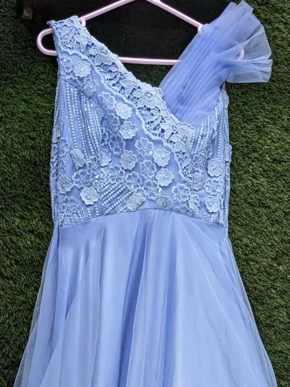 This sky blue gown with floral lace details is available as a mother-daughter set. It also has a detachable bottom ruffle for a versatile look.