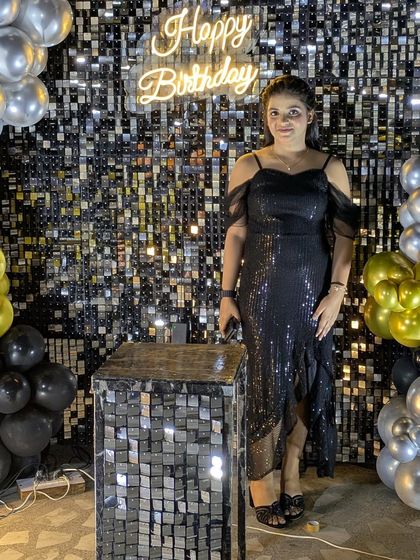 The sequin wall provides a fantastic, reflective background that makes party photos pop, especially at night.