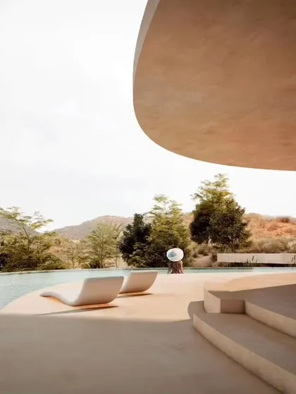 The Amar Villa in Udaipur, a boutique hotel designed as a seamless calligraphic curve that follows the site's natural topography. The architecture is designed to maximize breathtaking mountain views while blending into the surrounding landscape.