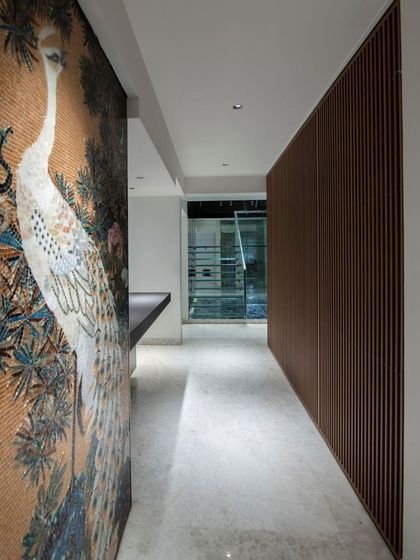 A stunning mosaic wall depicting a peacock, showcasing our ability to integrate intricate, large-scale art pieces into our interior designs.