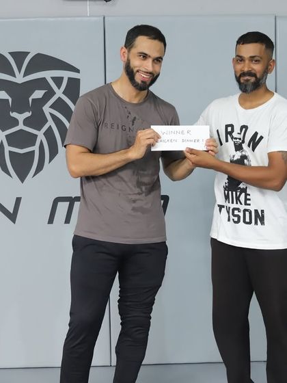 The captain of the winning team, "The Roll Models," receiving the cash prize after a dominant performance at our in-house event.