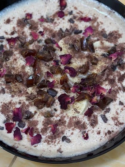 This creamy coconut-almond milk smoothie bowl is a dessert in itself. It has a whole fruit base and is garnished with dates, rose petals, and cacao nibs for a rich, decadent flavor.
