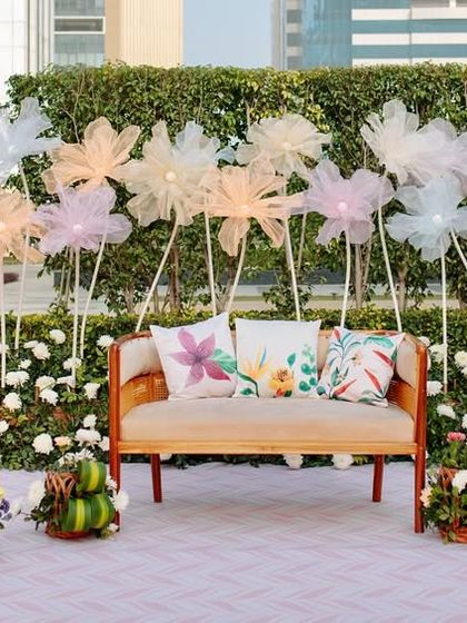 A wider view of the Haldi stage, showing the beautiful arrangement of fabric flowers that create a magical, meadow-like effect.