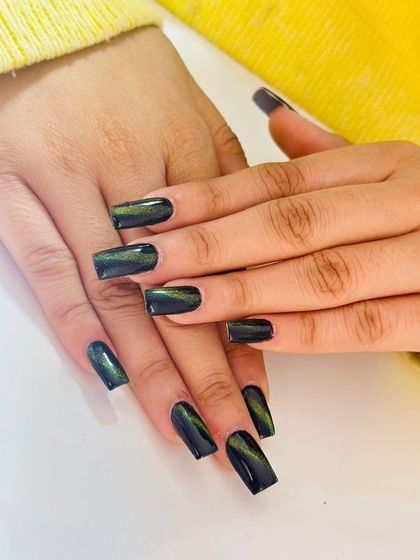 A sleek and modern set of square nails with a dark green cat-eye effect.