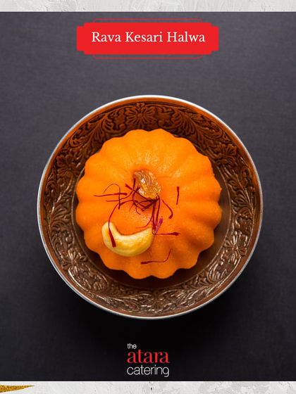 A beautifully molded Rava Kesari Halwa. This saffron-infused semolina dessert is a rich and aromatic sweet treat from our Indian dessert menu.