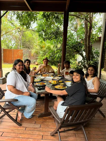 The team enjoying a meal together on the deck of The Mango House. These offsite trips are a great way to bond and find fresh inspiration outside the studio environment.