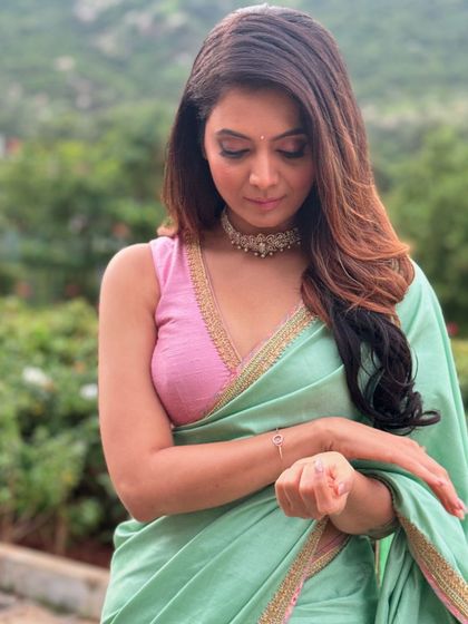 The beautiful Shwetha Prasad in a custom saree and blouse I designed. The pastel green saree is paired with a sleeveless pink blouse for a soft, modern look.