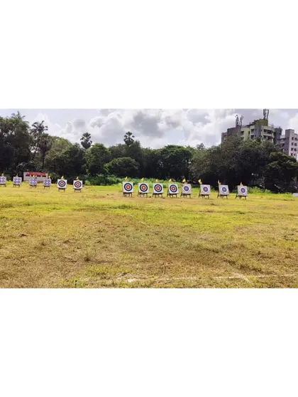 A wide-angle view of the competition range in Mumbai, showing multiple targets set up across the field for a large-scale event.