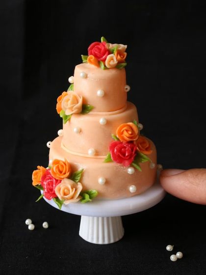 A beautiful three-tiered floral cake, perfect for a miniature wedding.
