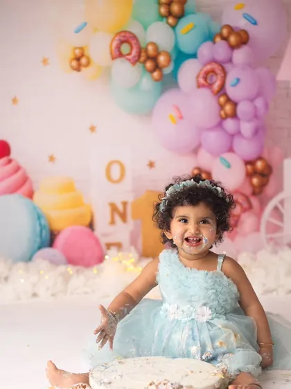 A picture of pure happiness. This little sweetheart's smile says it all about how much fun she had during her first birthday cake smash session.