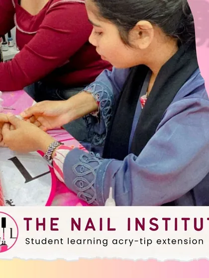 Here, a student is learning to apply and blend acry-tip extensions, a fundamental skill for creating length and strength.