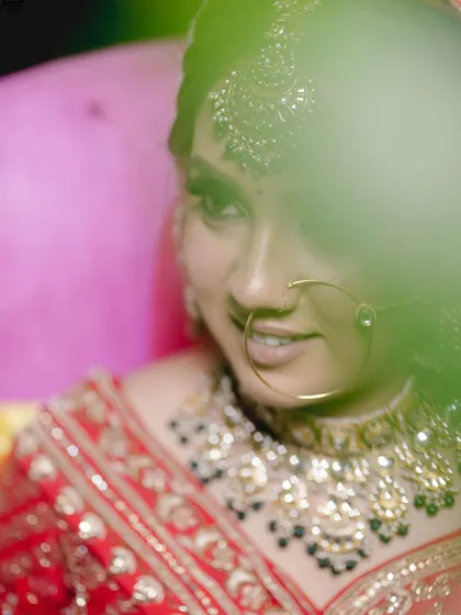 An artistic shot with a foreground blur, creating a dreamy and intimate bridal portrait.