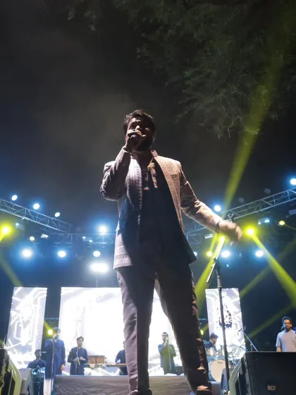 A full-length shot on stage, capturing the scale of the production at a college show.
