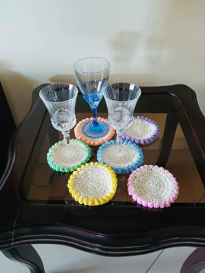 A set of funky and bright coasters, each with a different colored border. They are perfect for parties or for adding a splash of color to your coffee table.