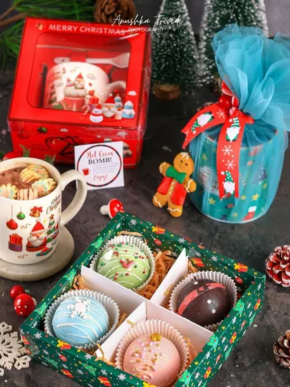 A festive gift set featuring hot cocoa bombs and a Christmas mug. This shot is perfect for showcasing a complete holiday product offering.