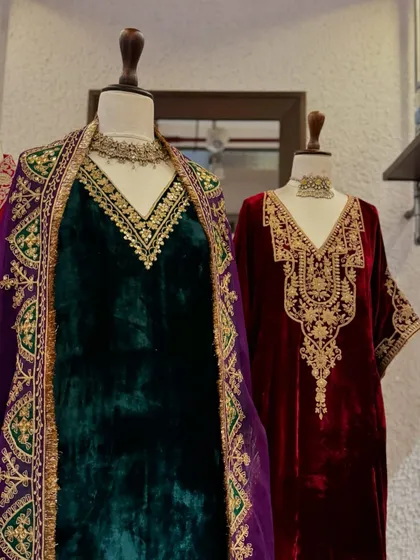 Embrace the cozy winter vibes with luxurious velvets. This display features rich jewel tones of emerald green and burgundy with heavy gold embroidery.
