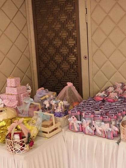 A wide shot of the complete baby shower gift table I set up. It shows a beautiful assortment of large hampers and smaller return favors, all coordinated to create a memorable experience.
