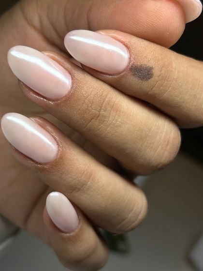The 'glazed donut' nail trend, perfected. This sheer, pearlescent nude gives a healthy and glowing finish to these beautifully shaped oval nails.