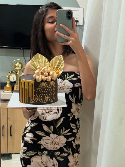 A mirror selfie with the elegant black and gold birthday cake. I love taking a moment to appreciate the final creation before it goes to its new home.