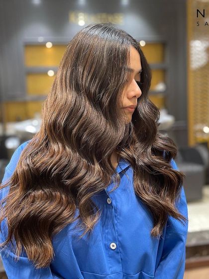 This angle shows the beautiful dimension created by the balayage technique, with ribbons of color running through her hair.