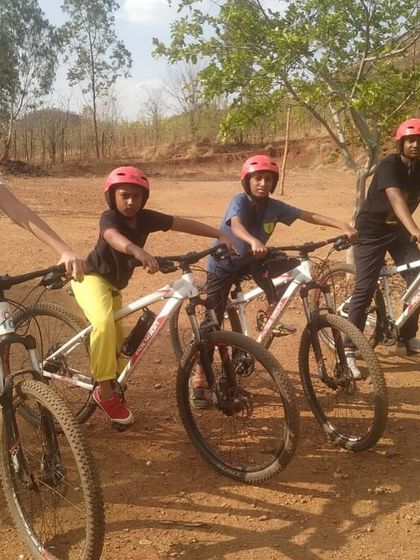 Four young campers with their mountain bikes, ready for an off-road adventure.