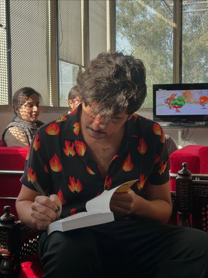 Author Jamal Ouazzani signs a copy of his book for our library. We actively seek to enrich our collection with works from contemporary Francophone and queer authors.