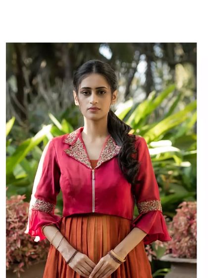 The dress is paired with a chic maroon jacket featuring a hand-embroidered collar, creating a perfect fusion of classic and contemporary styles.