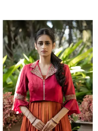 The dress is paired with a chic maroon jacket featuring a hand-embroidered collar, creating a perfect fusion of classic and contemporary styles.