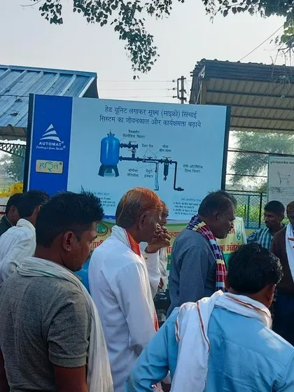 Farmers in Barwani, Indore, gather around a technical diagram explaining the setup of a micro-irrigation head unit. Visual aids like these are a key part of our training, making complex systems easy to understand.
