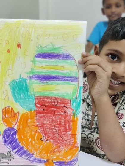 This cheerful artist created a Ganesha with a striped hat and a big smile. The bright colours and happy expression in the drawing reflect the joy of the creative process.