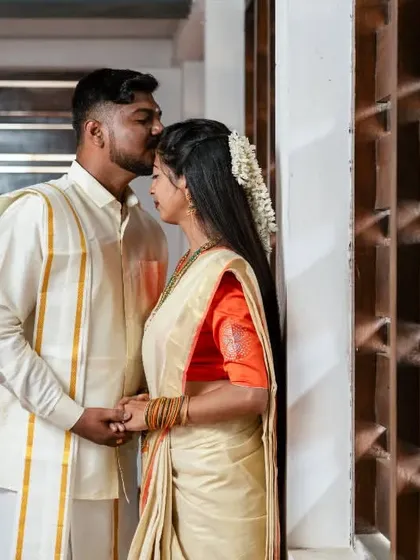 A tender forehead kiss during a culturally rich pre-wedding photoshoot, celebrating the couple's heritage.