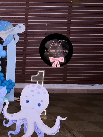 A friendly octopus cutout next to a light-up number '1', perfect for a first birthday celebration.