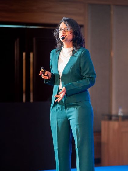 A photo of me speaking. AI can spit out words, but it's the human touch, the raw energy, and the courage to share your truth that makes a book unforgettable.