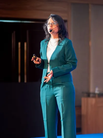 A photo of me speaking. AI can spit out words, but it's the human touch, the raw energy, and the courage to share your truth that makes a book unforgettable.