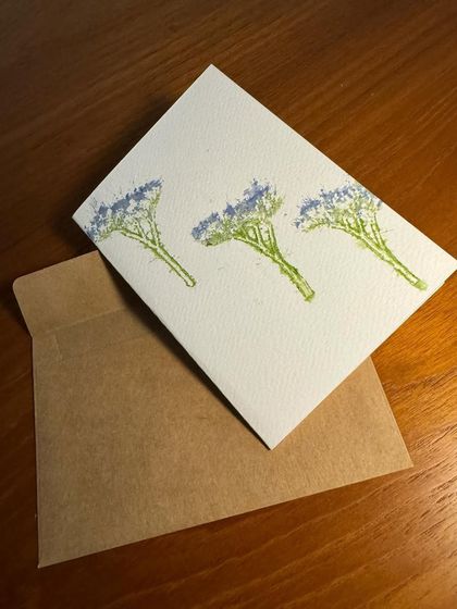This card features the delicate imprint of tiny blue flowers. The simple, elegant design showcases the beauty of using real botanicals in art. Each card comes with a rustic brown envelope.