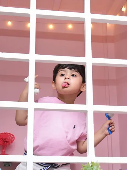A playful peek from inside our pink playhouse, a favorite spot for pretend play.