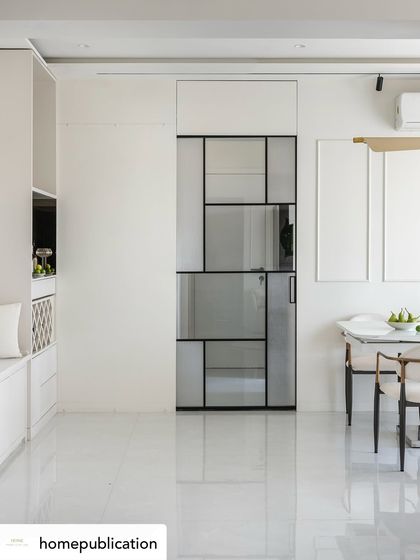A wide shot of a minimalist dining and living area from my 'Soothing Antidote' project. The design focuses on clean lines and a monochrome palette, where the geometric glass door itself becomes a form of art.