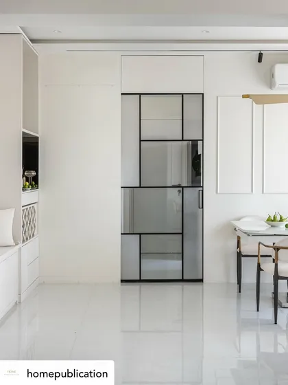 A wide shot of a minimalist dining and living area from my 'Soothing Antidote' project. The design focuses on clean lines and a monochrome palette, where the geometric glass door itself becomes a form of art.