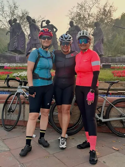 Three friends from the club posing together after a ride.
