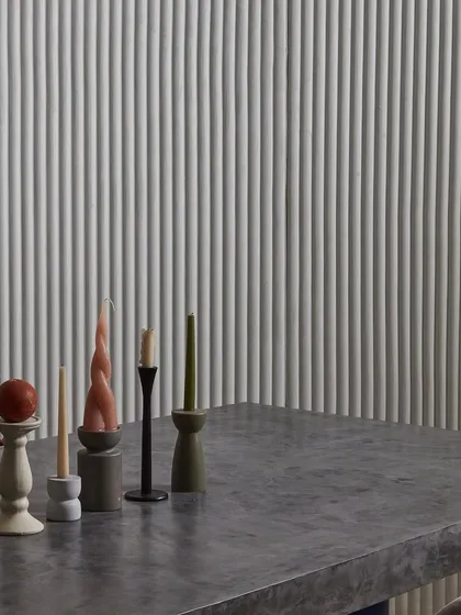 The play of light on this white, ribbed 3D wallcovering creates a beautiful, rhythmic pattern. It's a perfect example of how our designs infuse spaces with a velvety, architectural elegance.